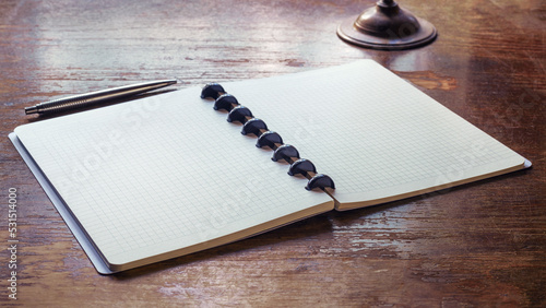 An open notebook with a pen...