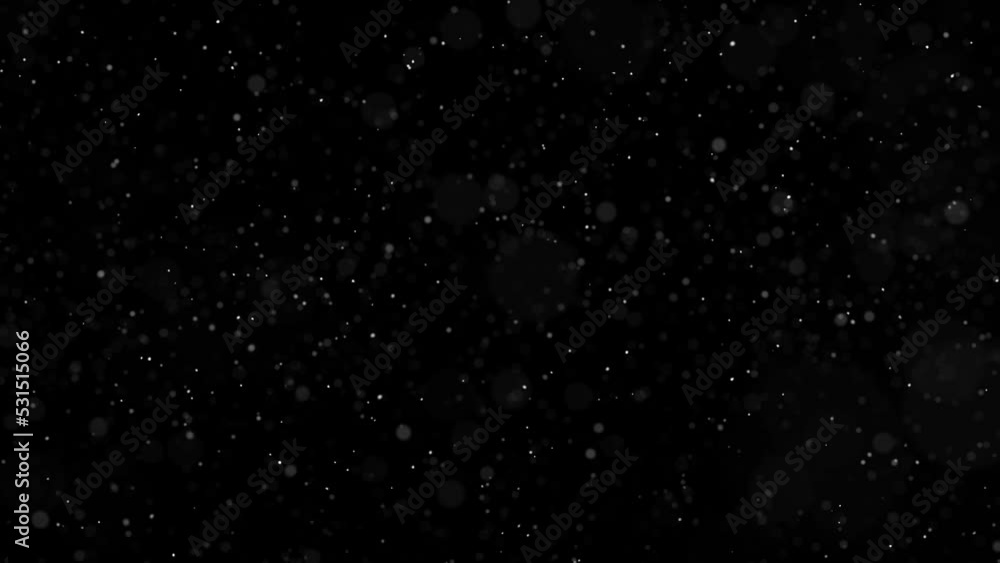 Seamless loop blurred snowflakes on clean black animation copy space background.