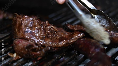 close-up with focus selection of beef entrails cow cut roasted on the grill argentina