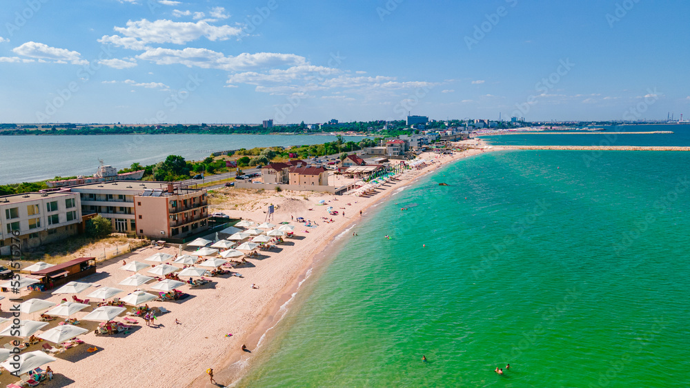 Aerial photography taken from a drone at Eforie beach with Techirghiol lake on the left side of the beach and the Black sea on the right side. A patch of land between sea and lake.