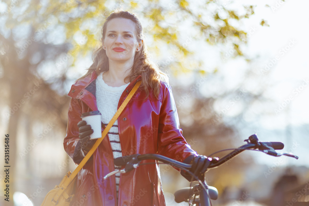 relaxed elegant woman in rain coat outside in city relaxed elegant woman in rain coat outside in city