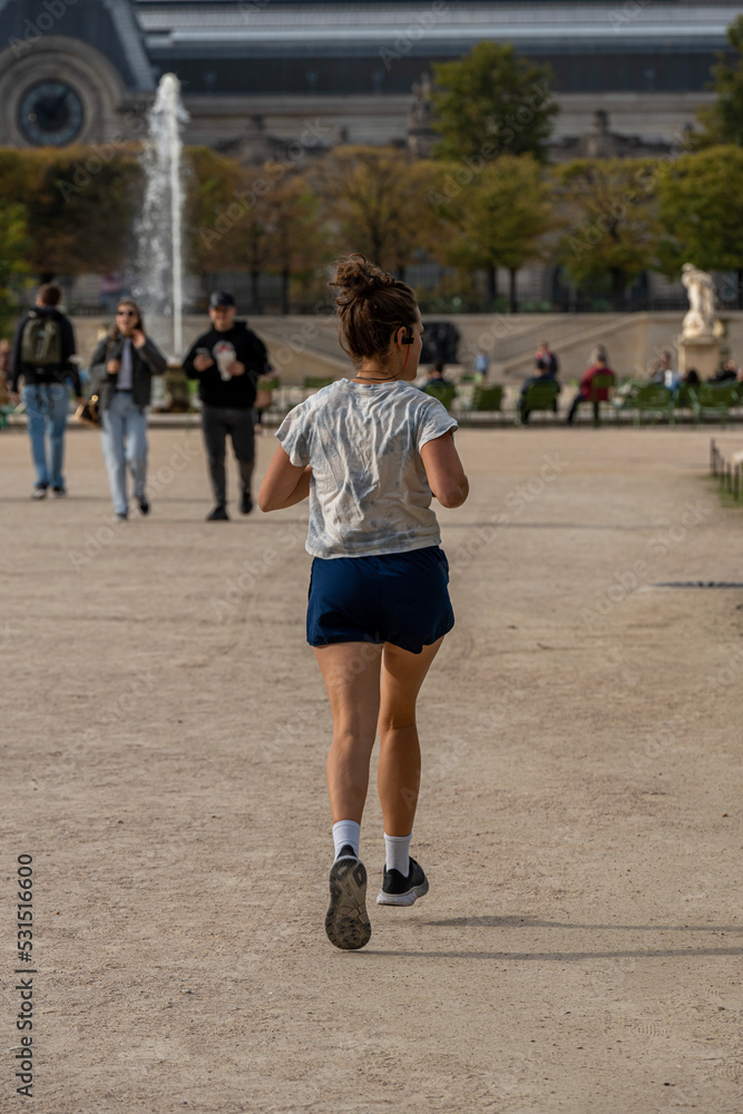 Paris, France - 09 16 2022: Tuileries garden. A woman running in the park