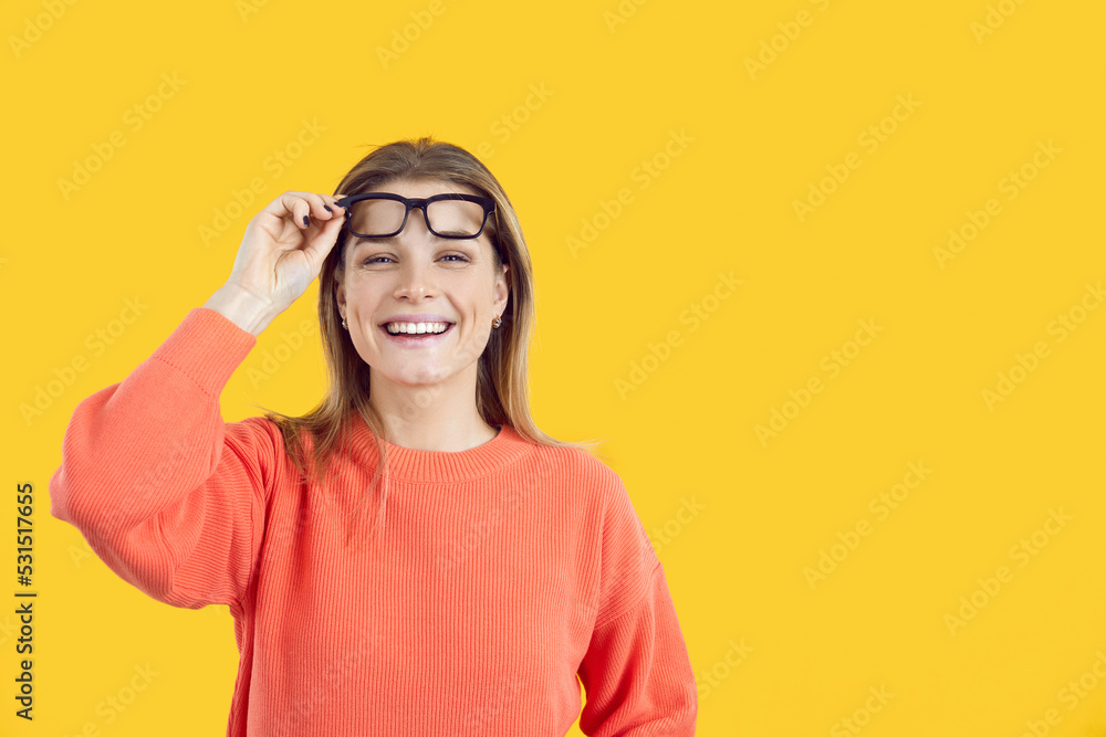 Portrait of smiling girl isolated on yellow studio background take off glasses consider good sale deal or discount. Happy young woman excited with promotion and offer. Copy space, ad. Portrait of smiling girl isolated on yellow studio background take off glasses consider good sale deal or discount. Happy young woman excited with promotion and offer. Copy space, ad.