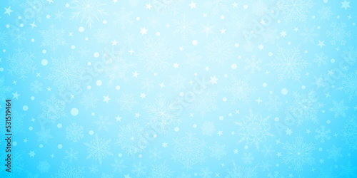 Background of complex big and small Christmas snowflakes in light blue colors. Winter illustration with falling snow