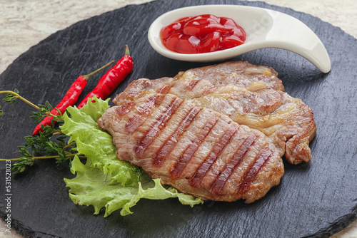 Grilled pork neck steak with ketchup