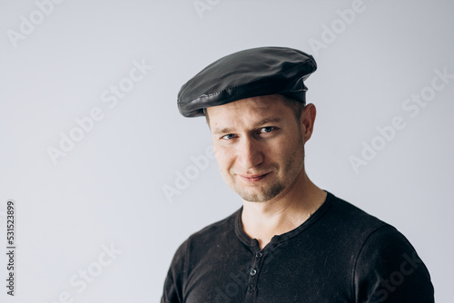 World France day, french guy in black t-shirt and beret stands and looks at camera. © Alexey