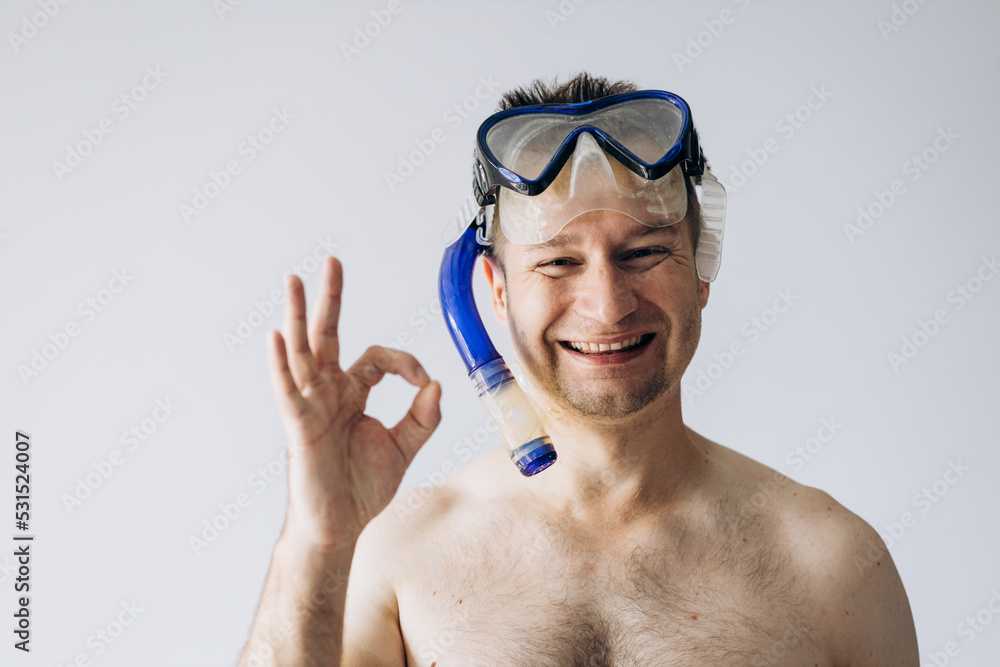 Handsome man in diving mask standing and looking at camera.