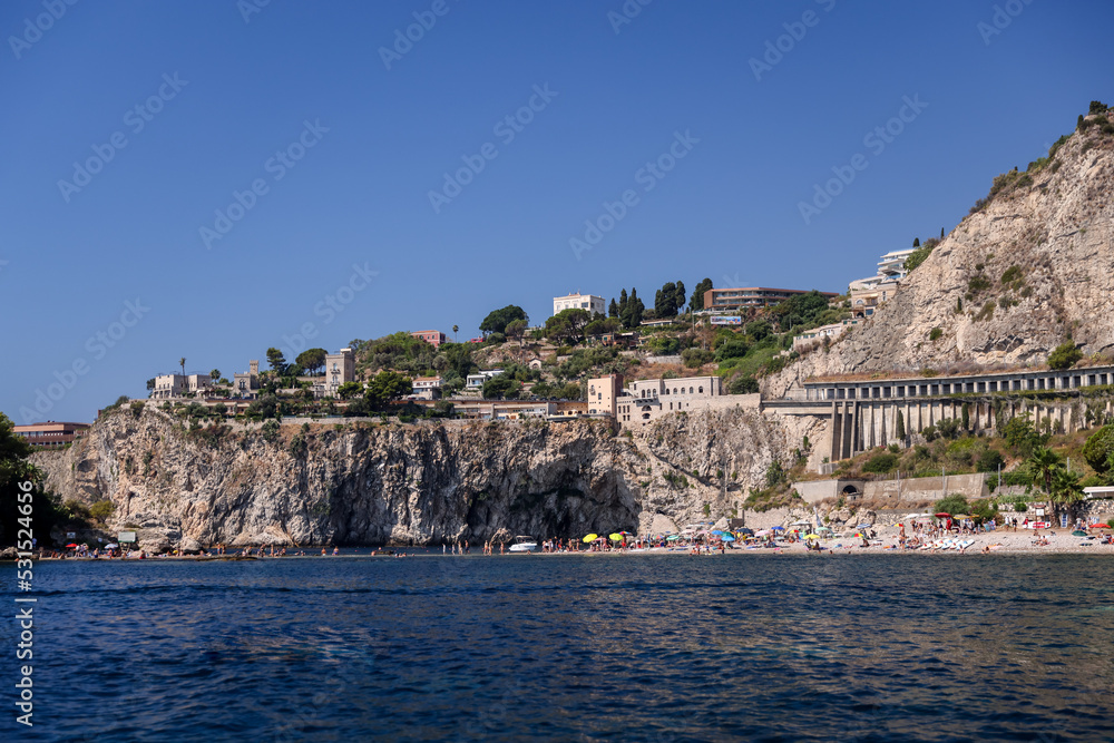 Taormina, Italy - July 22, 2022: The rocky seaside and coastline below Taormina in Sicily
