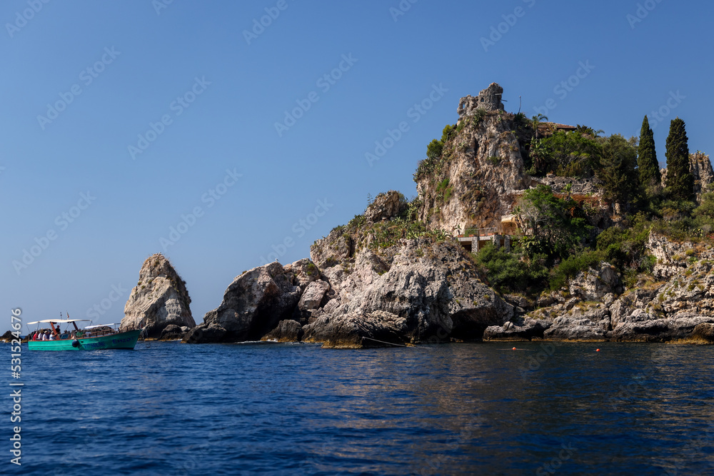 Naklejka premium Taormina, Italy - July 22, 2022: The rocky seaside and coastline below Taormina in Sicily