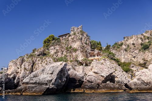 Taormina, Italy - July 22, 2022: The rocky seaside and coastline below Taormina in Sicily 
