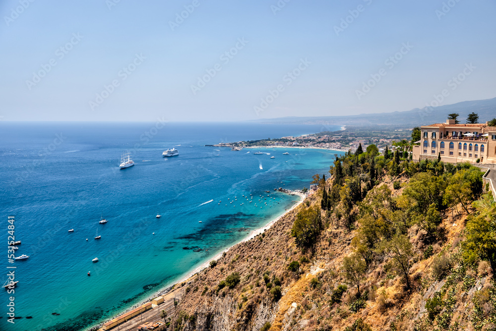 Taormina, Italy - July 22, 2022: Aerial views of the coastline below Taormina in Sicily
