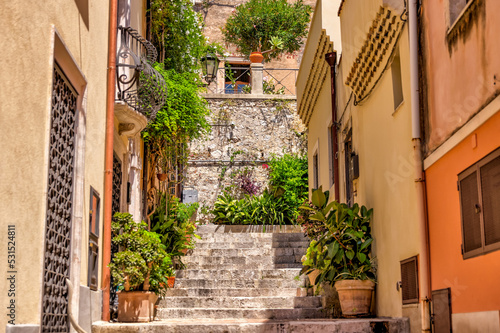 Fototapeta Naklejka Na Ścianę i Meble -  Taormina, Italy - July 22, 2022: Scenic streets and sidewalks in Taormina, Sicily
