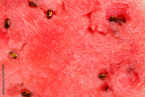Background red watermelon pulp with black seeds.