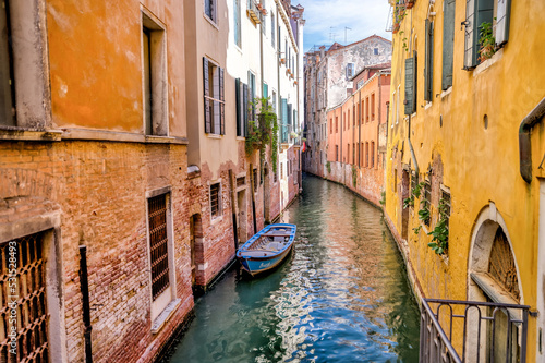 Venice, Italy - July 5, 2022: Building exteriors, boats and gondolas along the canals in Venice Italy 