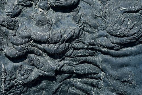 Oil tar frozen in waves, texture black rough background