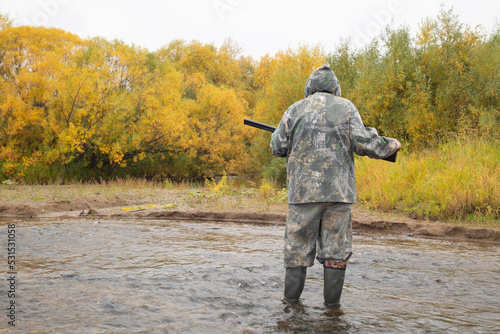 Duck hunting in autumn. A man with a gun is hunting ducks.