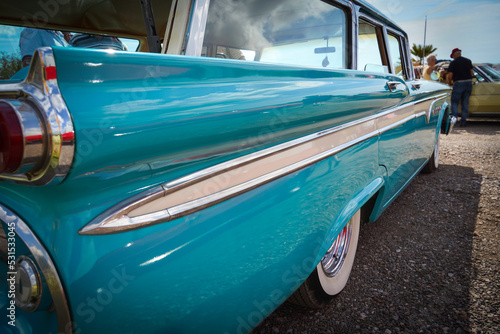 Close up view looking along a large classic American car, with selective focus photo
