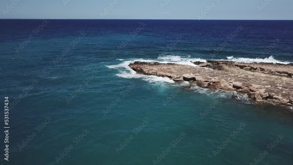 Aerial video of blue sea waves hitting the rocks Aerial video of blue sea waves hitting the rocks