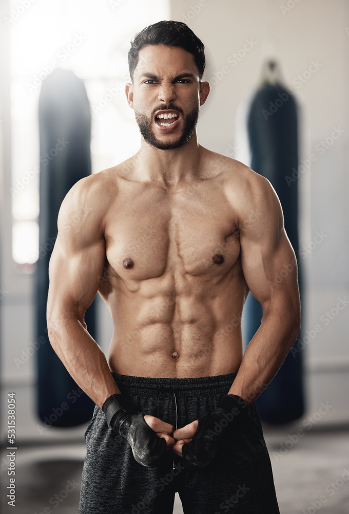 Fototapeta premium Fitness, sport and man boxer with motivation, vision or exercise goals, health and wellness in gym. Powerful flexing of healthy sports personal trainer with workout for muscle training body in studio