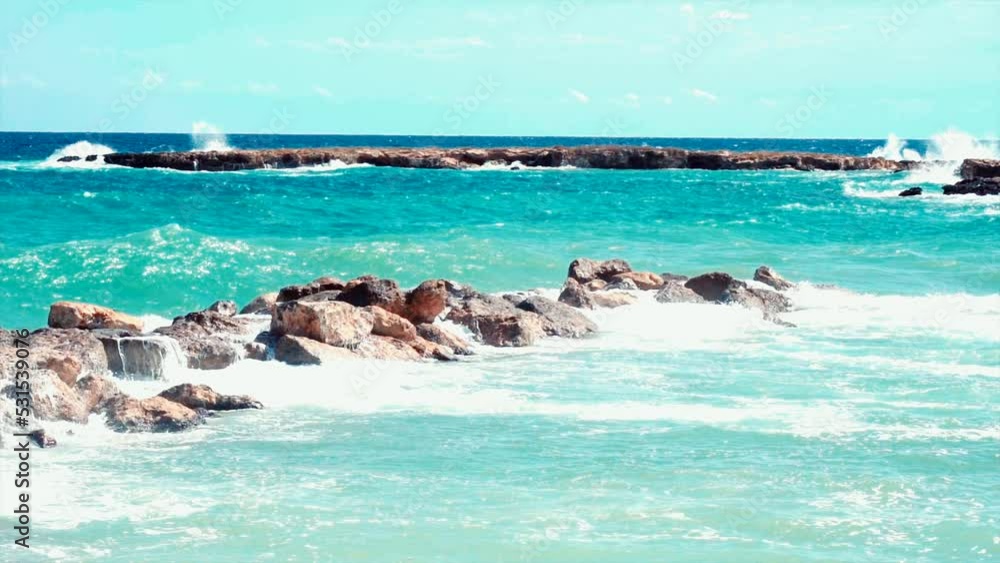 Video of blue sea waves hitting the big stones Video of blue sea waves hitting the big stones