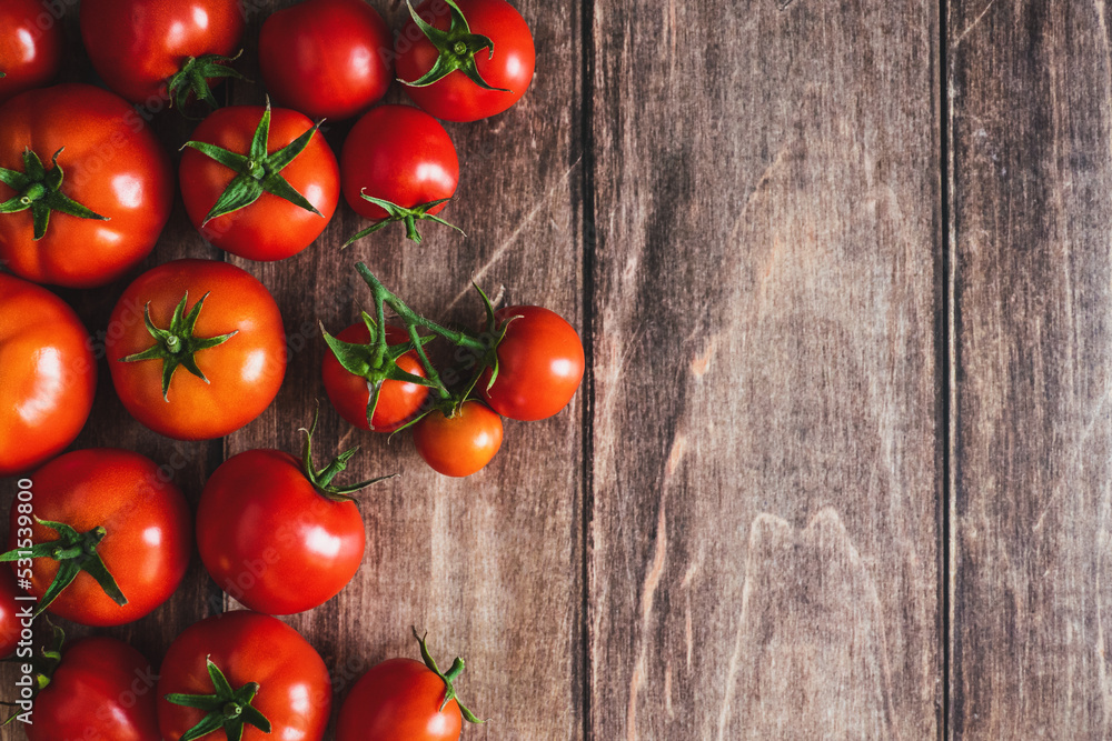 Tomatoes on wooden background, freshly picked red tomato fruit frame, cooking background, copy space Tomatoes on wooden background, freshly picked red tomato fruit frame, cooking background, copy space