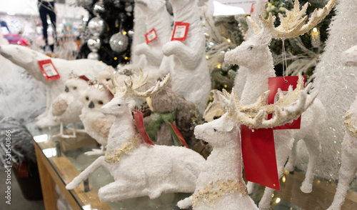 white reindeer Christmas adornments at sale in a market shop