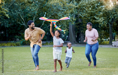 Fotografie Black family, kite and outdoor fun with parents and children having fun and playing outside at a park in nature