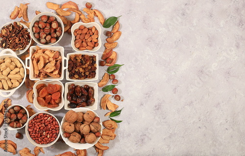 Assortment of various nuts and dried fruits, healthy natural food concept, almonds, nuts, pecans, pistachios, cashews, walnuts and pine nuts, apples, raisins, dried apricots, 