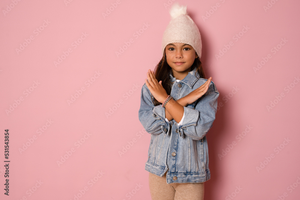 Photo portrait girl serious showing enough stop sign crossed hands isolated pastel pink color background Photo portrait girl serious showing enough stop sign crossed hands isolated pastel pink color background