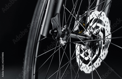 Disc brakes on a new bicycle close-up on a black background. Studio shot. Professional sport equipment.