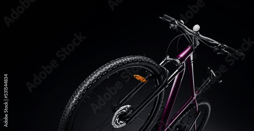 New modern mountain bike on a black background. Studio shot. Professional sports equipment. photo