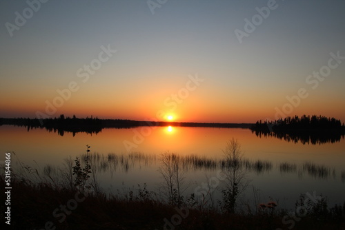 Fototapeta Naklejka Na Ścianę i Meble -  Sunset Glow On The Water, Elk Island National Park, Alberta
