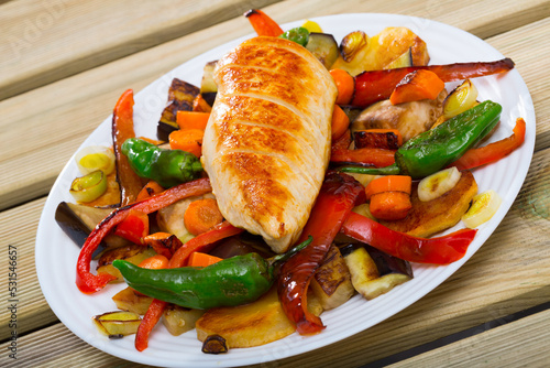 Fototapeta Naklejka Na Ścianę i Meble -  Grilled assorted vegetables served with baked chicken breast - traditional Bulgarian Plakiya