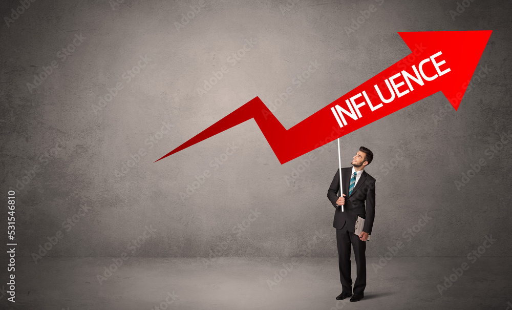 Young business person in casual holding road sign