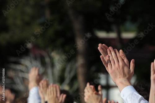 Group of people clapping their hands up their fingers close up