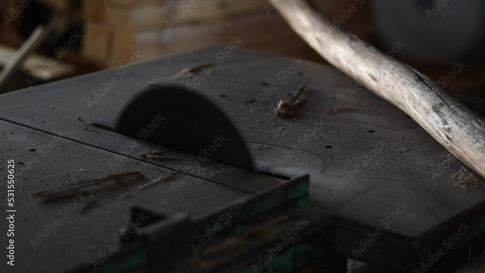 unrecognizable man cuts wooden logs with electric saw with selected focus unrecognizable man cuts wooden logs with electric saw with selected focus