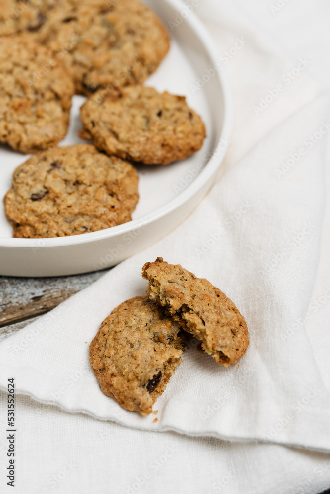 Freshly baked müsli and oatmeal raisin cookies, traditional American biscuits made of flour, rolled oats, oat meal, muesli, sugar, eggs, raisins or sultanas and baking soda or powder, chewy and soft Freshly baked müsli and oatmeal raisin cookies, traditional American biscuits made of flour, rolled oats, oat meal, muesli, sugar, eggs, raisins or sultanas and baking soda or powder, chewy and soft