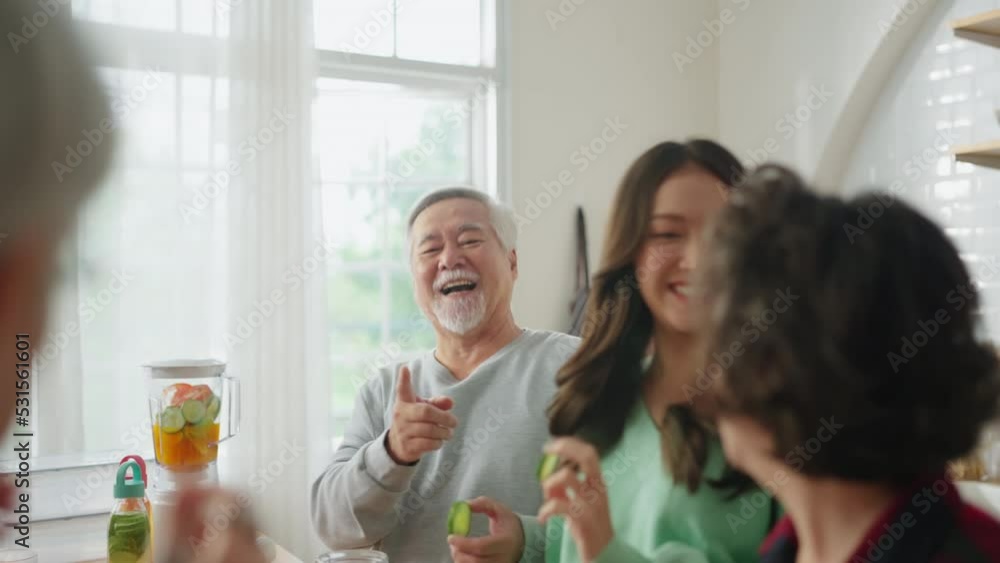 Group of senior friends having party indoors, cooking and talking positive conversation in senior daycare,asian Senior male standing in kitchen and relaxing at home while eating a healthy food recipe Group of senior friends having party indoors, cooking and talking positive conversation in senior daycare,asian Senior male standing in kitchen and relaxing at home while eating a healthy food recipe