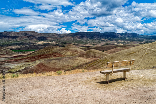 A bench overlooks the landscape at the Painted Hills Unit of the John Day Fossil Beds National Monument in Oregon, USA photo