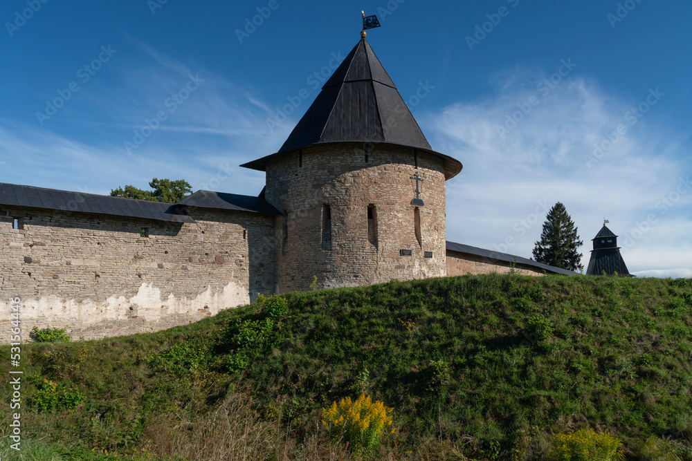 View of the Izborsk Tower of the Holy Dormition Pskov-Pechersk Monastery on a sunny summer day, Pechory, Pskov region, Russia