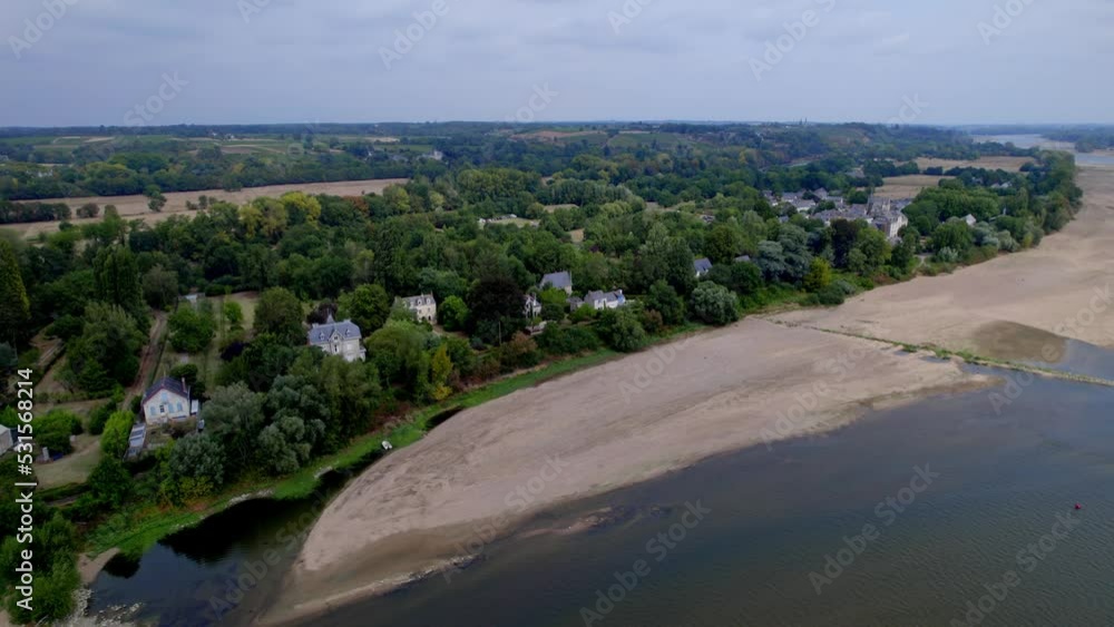 Luxury houses in Béhuard on banks of Loire river during dry season, France. Aerial circling Luxury houses in Béhuard on banks of Loire river during dry season, France. Aerial circling