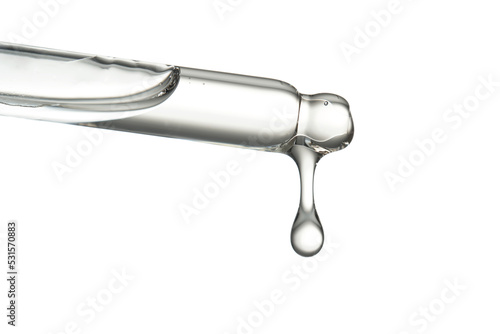 Pipette with a drop of cosmetic product on a white background.