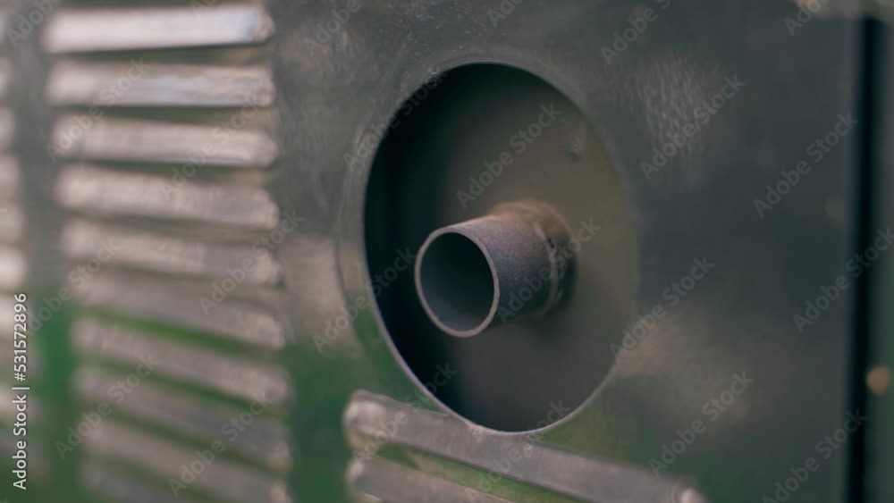 Small exhaust pipe under black protective housing. Smooth parallax. Exhaust pipe of a gasoline electric generator close-up Small exhaust pipe under black protective housing. Smooth parallax. Exhaust pipe of a gasoline electric generator close-up