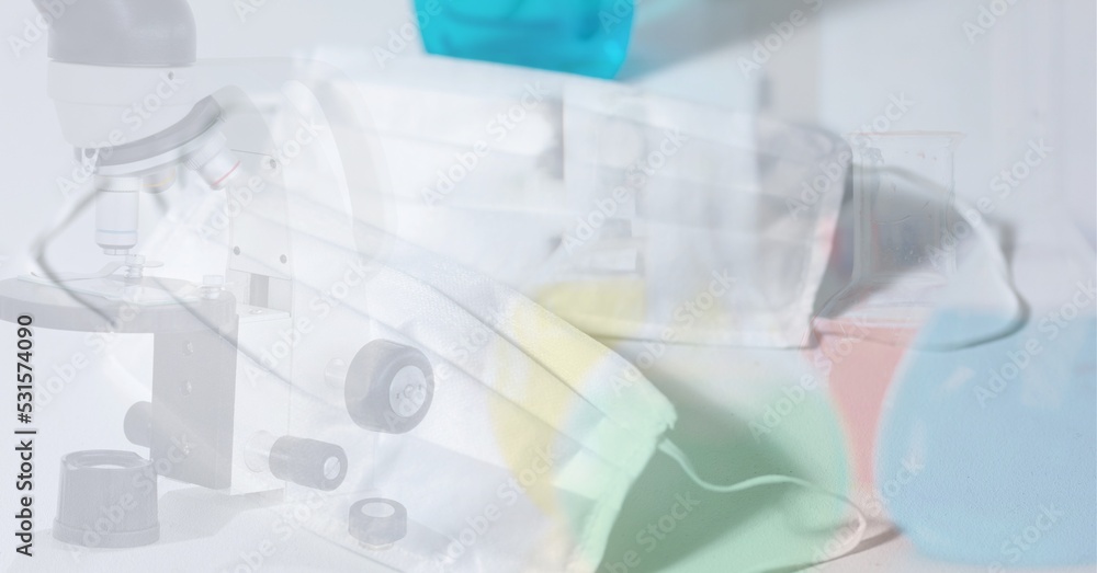 Digital illustration of a face mask lying on a table over a microscope Digital illustration of a face mask lying on a table over a microscope
