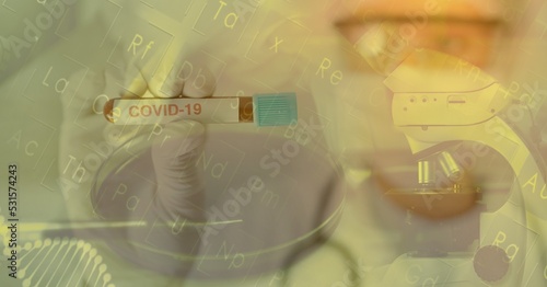 Digital illustration of a scientist holding a test tube with a COVID-19 sign over a microscope