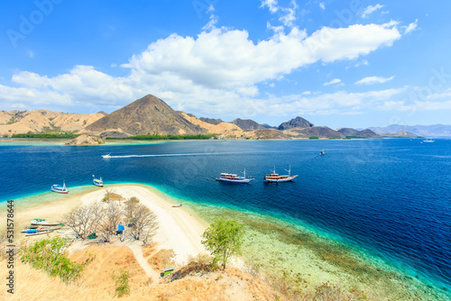 Panorama view of beaches and tourist boat sailing in Kelor Island, Flores Island, Indonesia photo