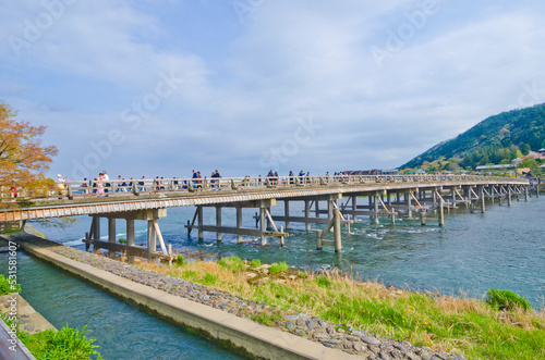 People crossing the Oi River on Togetsukyo Bridge in Arashiyama, Japan.