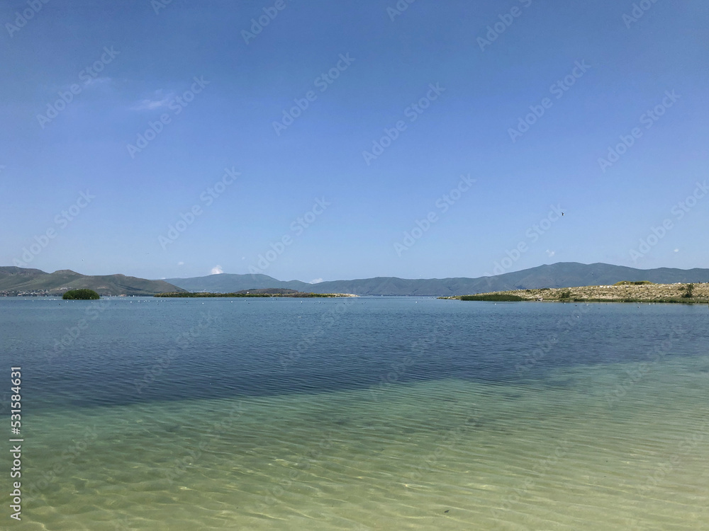 A pond with clear transparent water. Mountain Lake. Lake Sevan in Armenia. A pond with clear transparent water. Mountain Lake. Lake Sevan in Armenia.