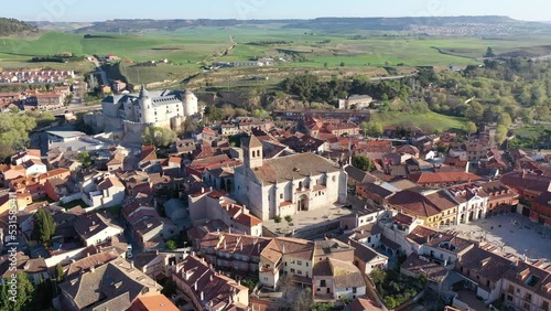 Aerial view of Spanish township of Simancas in province of Valladolid with Romanesque medieval church of El Salvador and walled fortified castle surrounded by residential buildings on sunny spring day photo