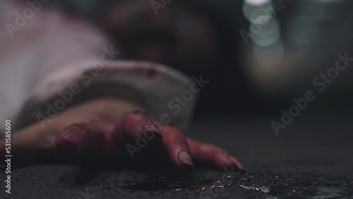 Closeup hand with blood of horror bloodthirsty ghost woman on floor, Homicide female hands jerky in blood with resentment torture and ask for help, murder and crime, Halloween horror day concept photo